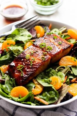 Asian Salmon Salad with a fork and dressing on the side