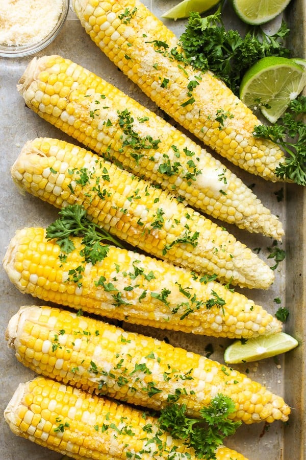 Oven Roasted Corn on the Cob sprinkled with parmesan cheese and parsley