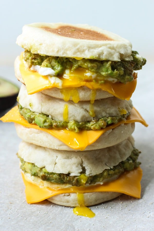 Closeup of three breakfast sandwiches stacked on top of each other
