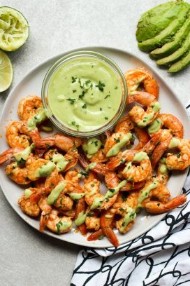 A plate of Chili Lime Shrimp drizzled with avocado crema