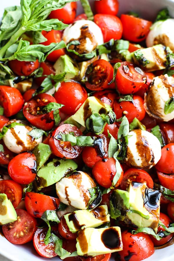Closeup of caprese salad with avocado