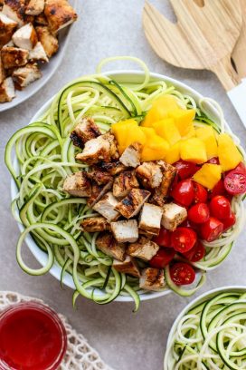 A bowl of Grilled Chicken Zoodles with BRIANNAS blush wine vinaigrette on the side