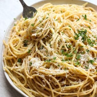 Fork digging into a plate of Lemon Garlic Parmesan Pasta