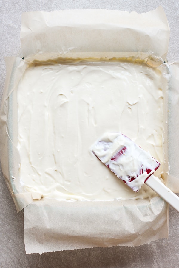 Spreading cream cheese mixture onto casserole dish