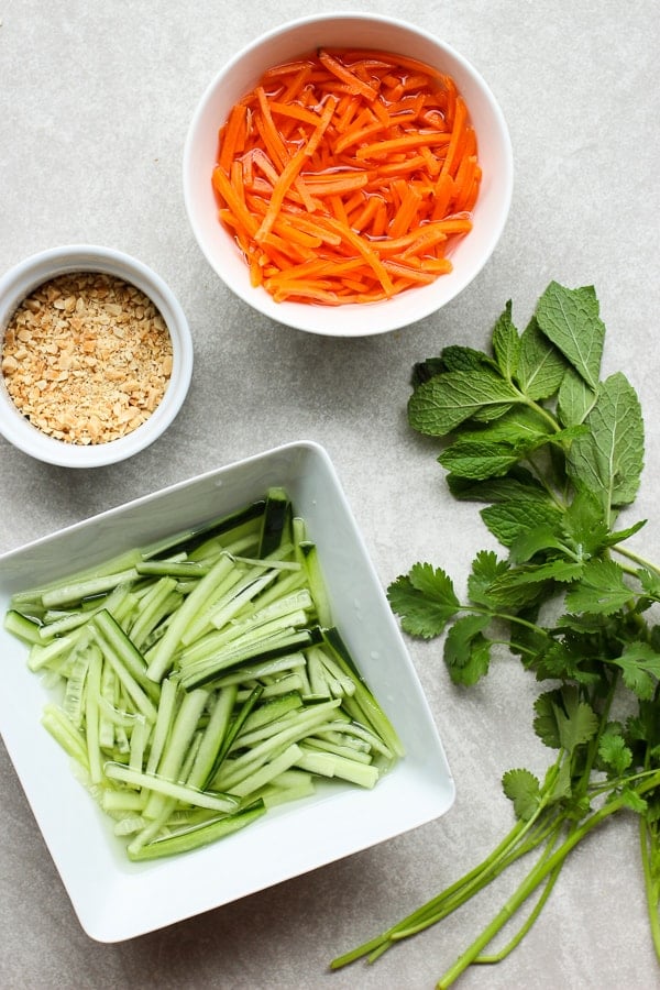 Shredded carrots, peanuts, shredded cucumber, cilantro and mint leaves