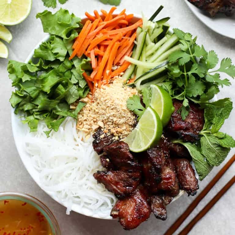 rice vermicelli noodles topped with veggies and grilled pork