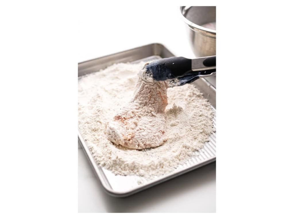 Coating chicken in flour mixture