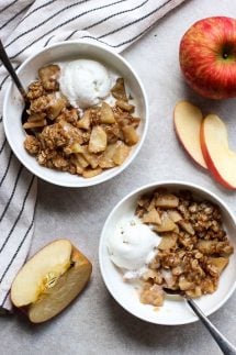 To bowls of Easy Apple Crisp topped with vanilla ice cream