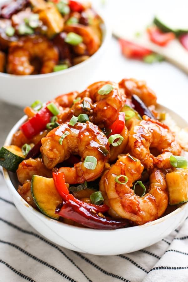 A bowl of Kung Pao Shrimp with another in the background