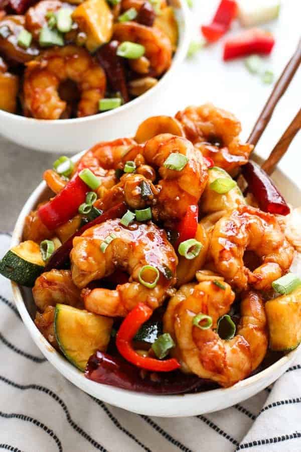 A bowl of Kung Pao Shrimp with chopsticks in the bowl