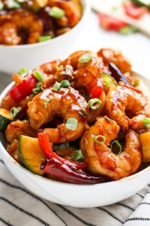 A bowl of Kung Pao Shrimp with another in the background