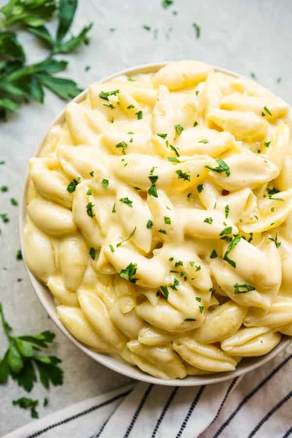 A large bowl of Adult Macaroni and cheese sprinkled with chopped parsley