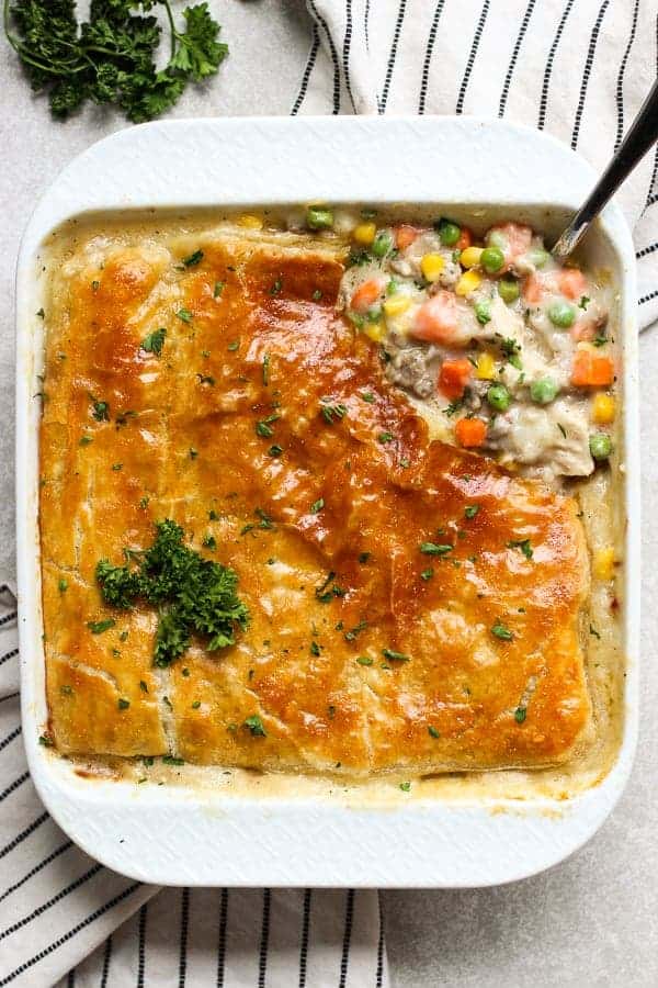 A top down view of chicken pot pie filling top with a layer of puff pastry