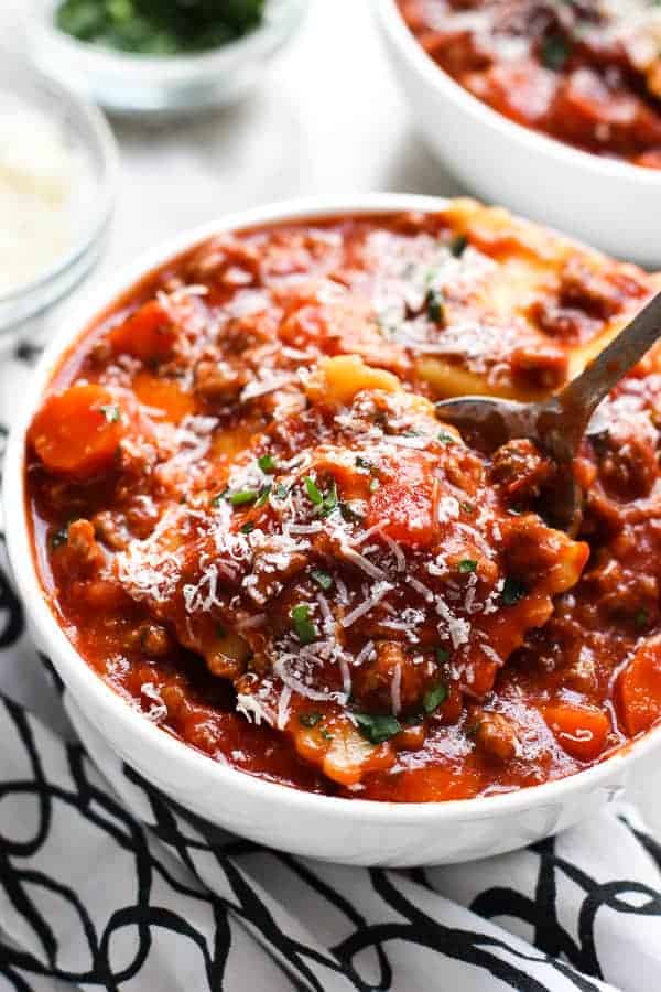 LIfting up a ravioli from Ravioli Beef Soup with a spoon