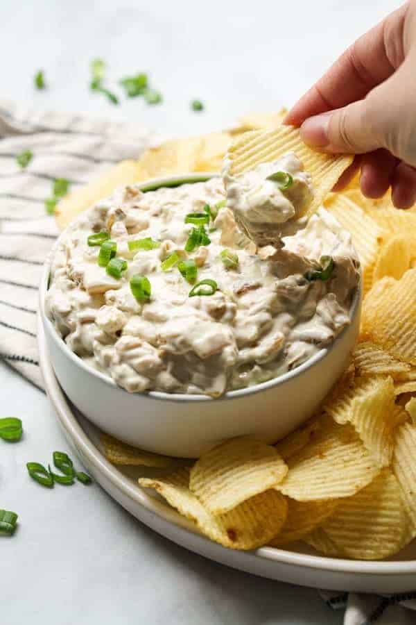 Dipping a potato chip into a dip