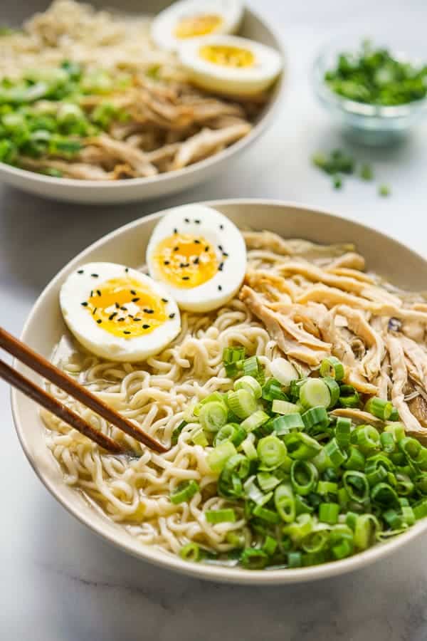 chopsticks in a bowl of noodles