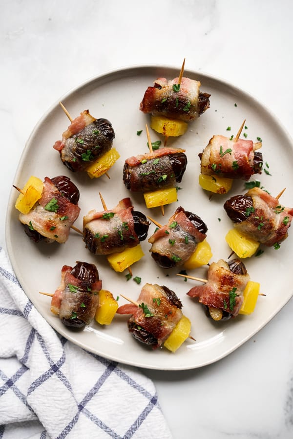 A plate of Bacon Wrapped Dates with Pineapple