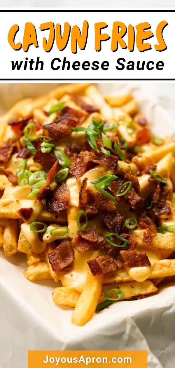 Baked Cajun Fries with Cheese Sauce - easy baked fries in cajun seasoning topped with homemade cheese sauce, bacon and green onions. A yummy appetizer and game day food! via @joyousapron