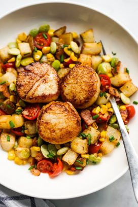 Garlic butter scallops on a bed of Succotash made with potatoes, corn, and lima beans