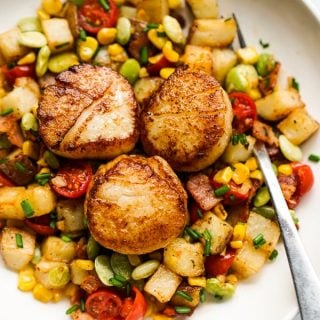 Garlic butter scallops on a bed of Succotash made with potatoes, corn, and lima beans