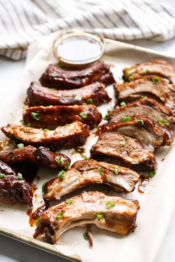 Slow Cooker Asian Ribs on a pan lined with parchment paper