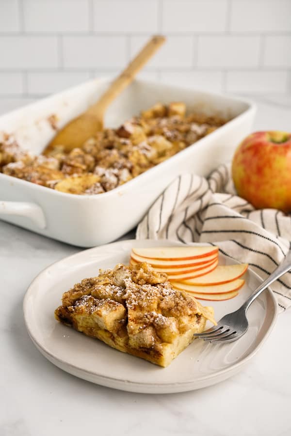 A plate of Apple French Toast with the casserole dish behind it