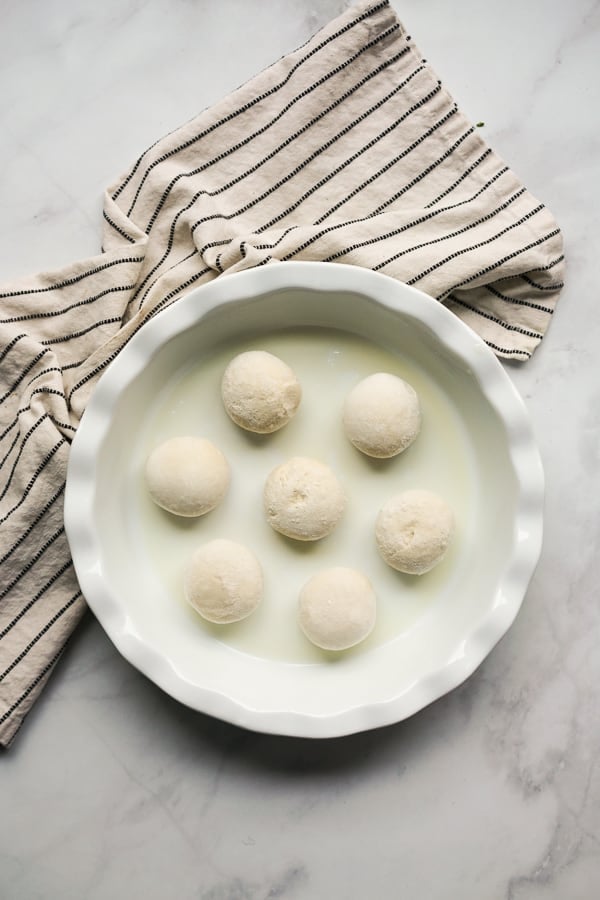 Small round frozen dough on a pan