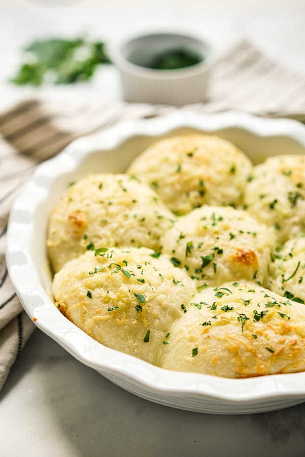 A round pan filled with warm Garlic Cheese Rolls