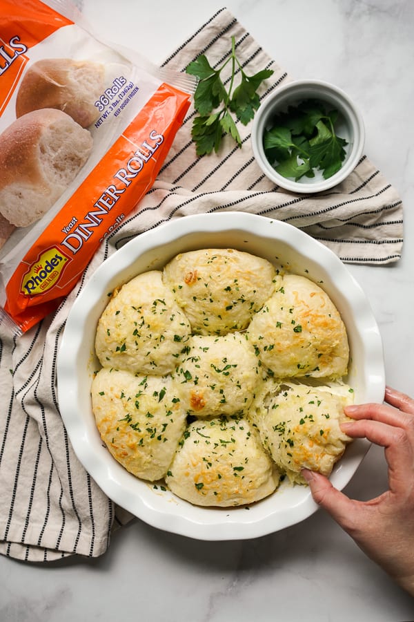 Pulling a piece of rolls from a pan