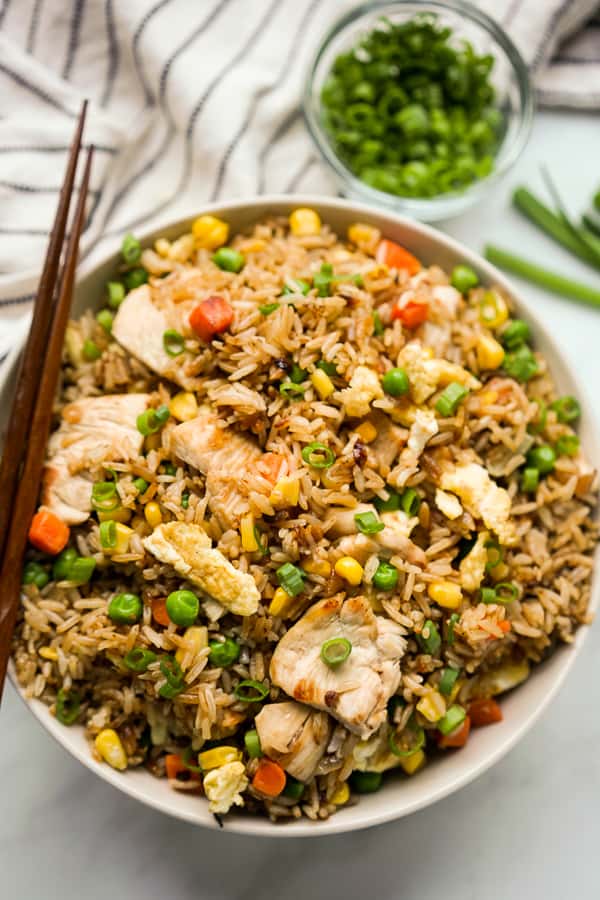A closeup bowl of fried rice with chicken and mixed vegetable