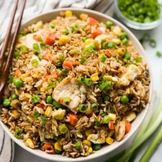A bowl of fried rice with chicken and mixed vegetable
