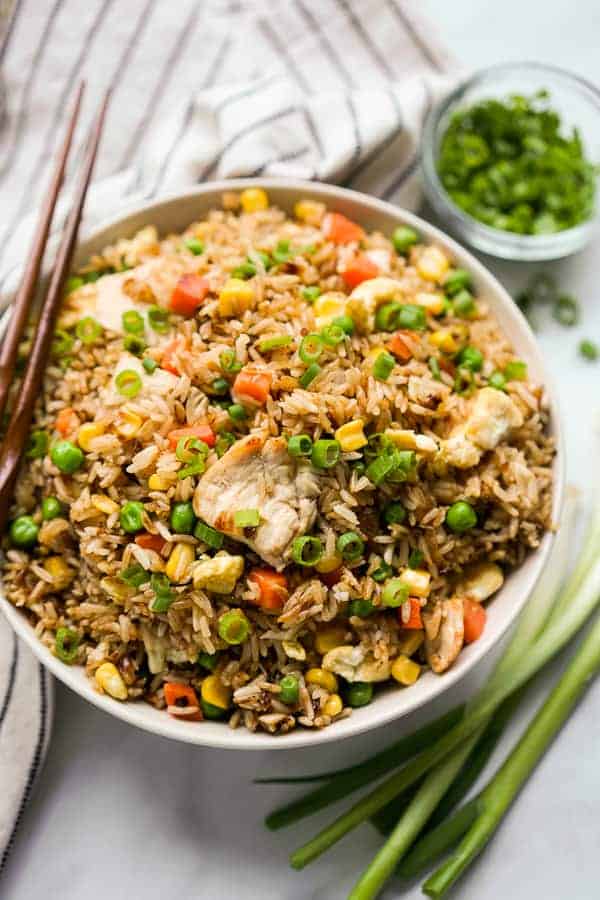 A bowl of fried rice with chicken and mixed vegetable