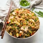 Fried rice with chicken in a bowl, with chopsticks on the bowl