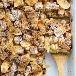 wooden spatula scooping out a square piece of french toast bake