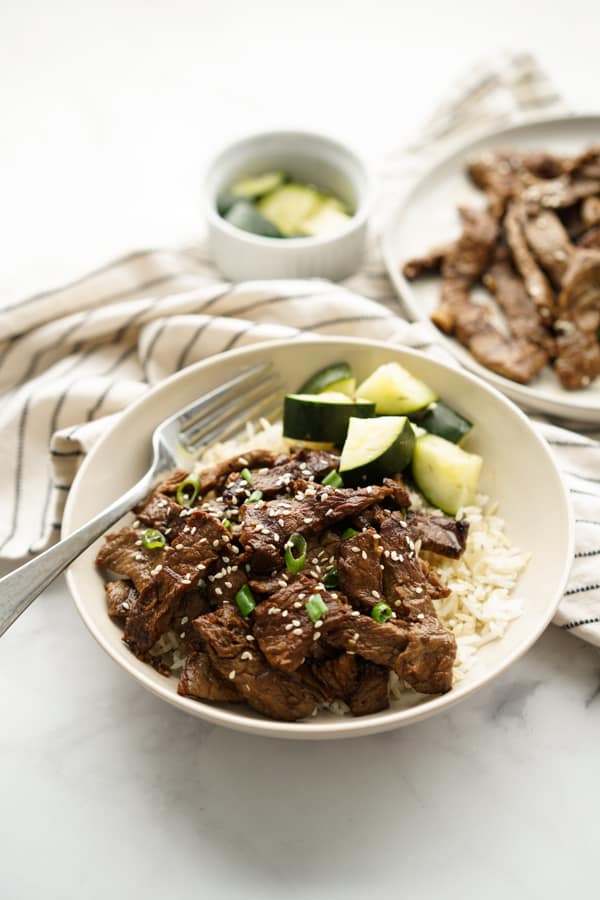 A bowl of Beef Bulgogi served with rice and cucumbers