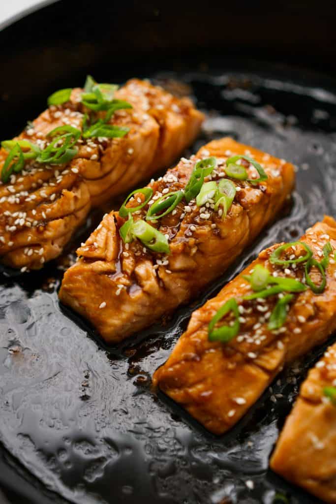 Pan Fried Teriyaki Salmon topped with green onions and sesame seeds