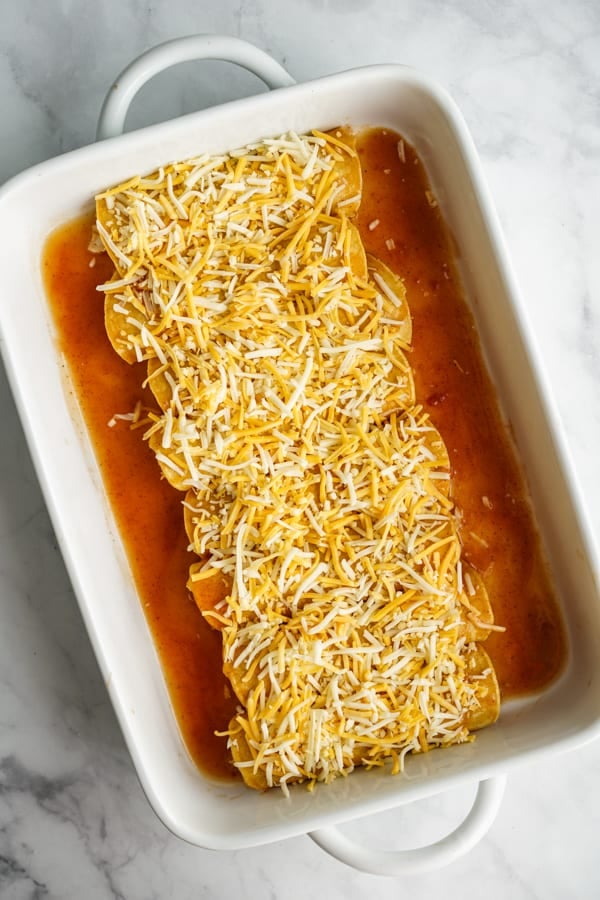 Uncooked chicken enchilada in rectangular casserole