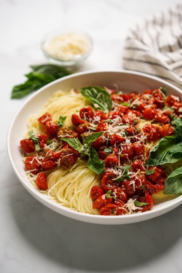 A bowl of Roasted Tomato Pasta with parmesan and fresh basil