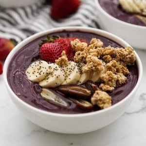 Acai bowl topped with strawberries dates and granola