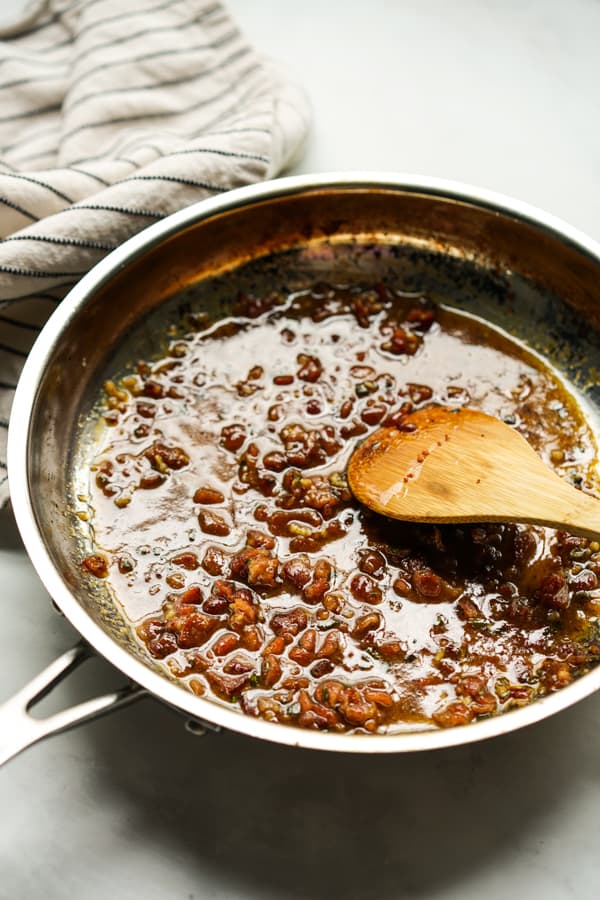 Bacon vinaigrette on a skillet with a spatula