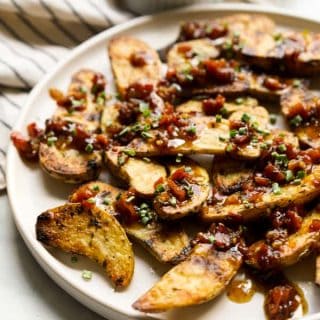 A plate of fingerling potatoes with bacon pieces