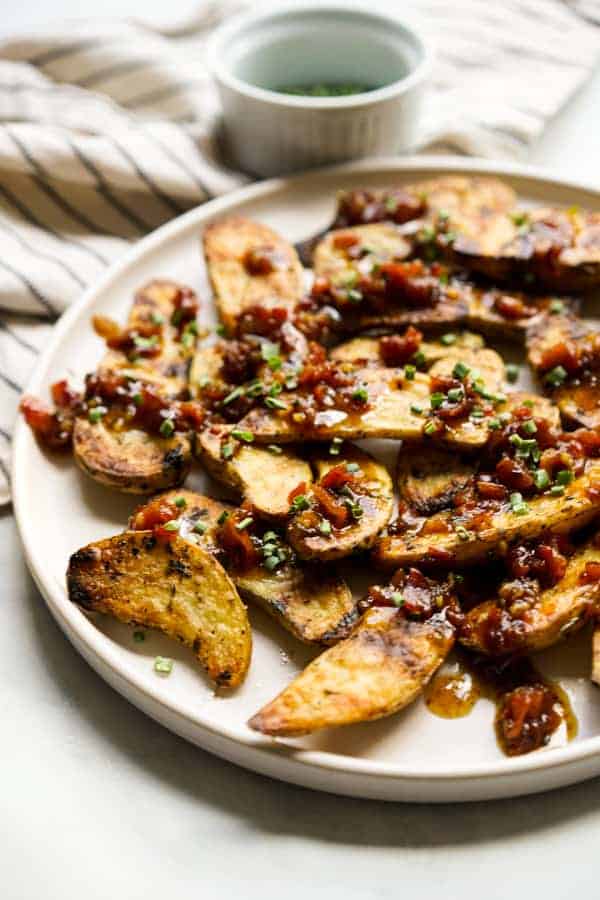 A plate of fingerling potatoes with bacon pieces