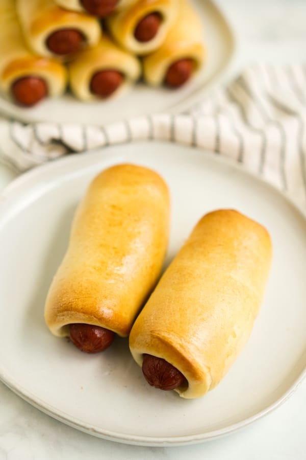 Two sausage kolaches on a plate