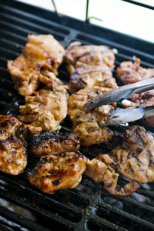 Grilling chicken thighs on the charcoal grill