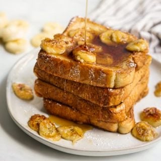 Drizzling maple syrup onto a stack of french toast