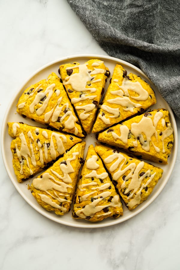 Top down view of a plate of triangular scones forming a round shape