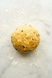 Rolled scones dough into a ball on floured surface