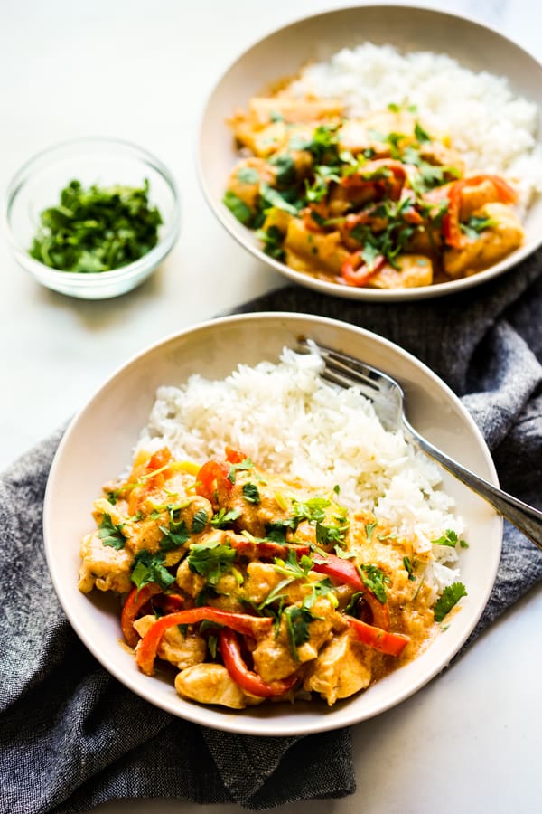 Two bowls of rice topped with Thai Red Curry with Chicken