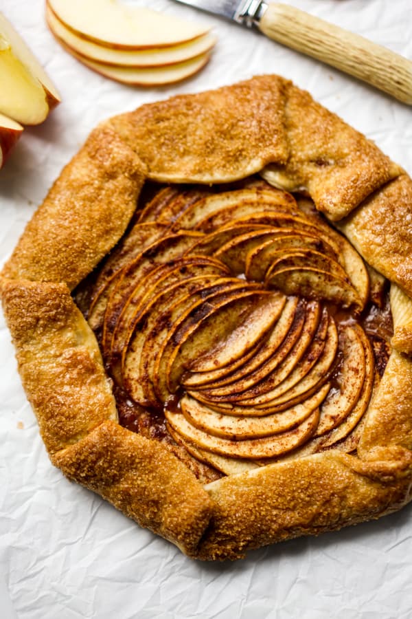 An oval unsliced apple crostata