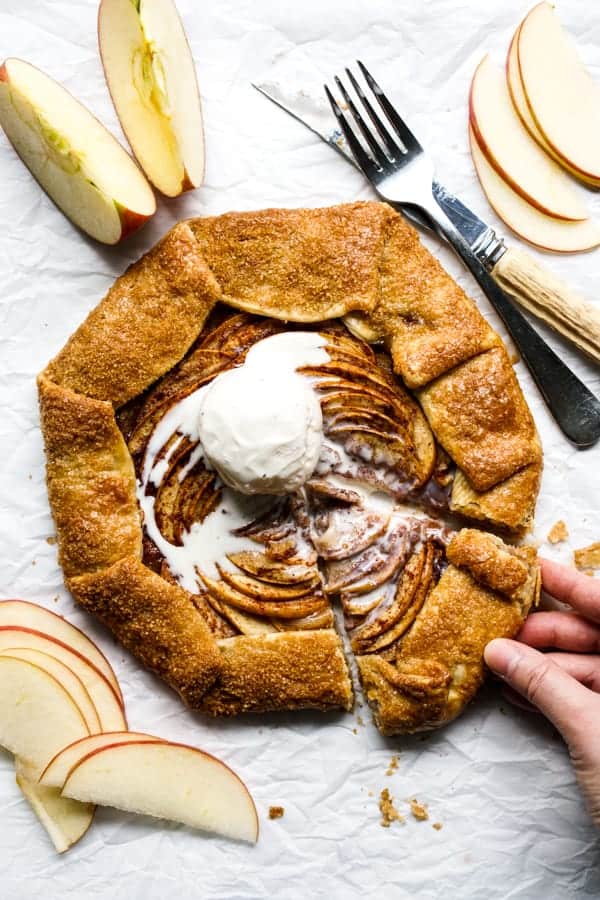 Hand grabbing a slice of apple cinnamon galette